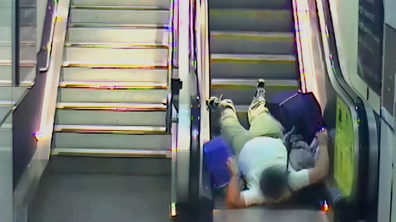 lelaki terjatuh semasa mendaki eskalator